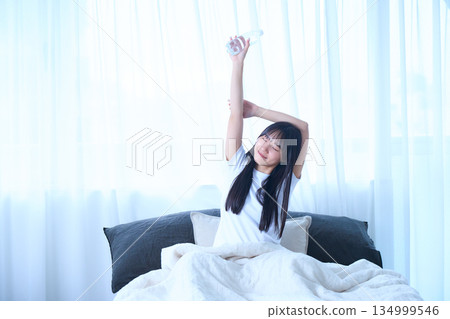 Stretching your arms in bed 134999546