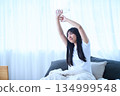 Stretching your arms in bed 134999548