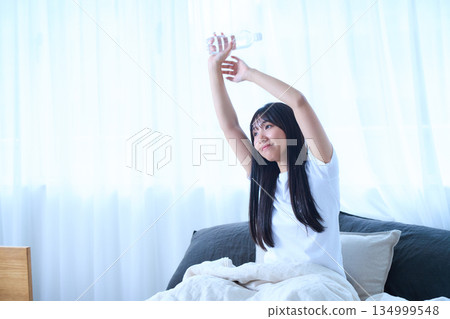Stretching your arms in bed 134999548