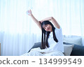 Stretching your arms in bed 134999549