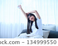 Stretching your arms in bed 134999550