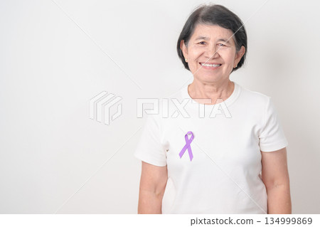 Elderly woman with light Purple Ribbon for All cancer, April Esophageal Cancer, January Thyroid disease, September Hodgkin Lymphoma, Awareness month and February World cancer day concepts 134999869
