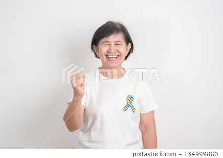 Elderly with LGBTQ Rainbow ribbon for concept of June Pride month, April Autism Awareness, All cancer Awareness, February World Cancer day, October World Hospice and Palliative care day and Survivor Elderly with LGBTQ Rainbow ribbon for concept of June Pride month, April Autism Awareness, All cancer Awareness, February World Cancer day, October World Hospice and Palliative care day and Survivor 134999880