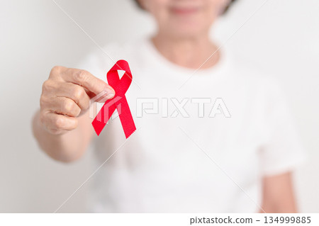 Elderly with Red Ribbon for December World Aids Day, MADD, October Red ribbon week, February Heart month, Marfan Syndrome, May Stroke awareness, March world TB Tuberculosis day and April Dare day 134999885