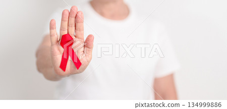Elderly with Red Ribbon for December World Aids Day, MADD, October Red ribbon week, February Heart month, Marfan Syndrome, May Stroke awareness, March world TB Tuberculosis day and April Dare day 134999886