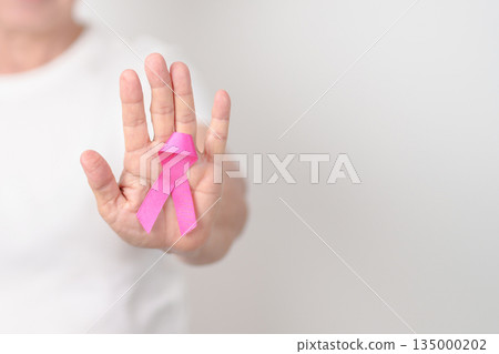 Elderly woman with pink Ribbon for Pink October Breast Cancer Awareness month, May Women Health, February World cancer day, support people life and illness. National cancer survivors month Elderly woman with pink Ribbon for Pink October Breast Cancer Awareness month, May Women Health, February World cancer day, support people life and illness. National cancer survivors month 135000202