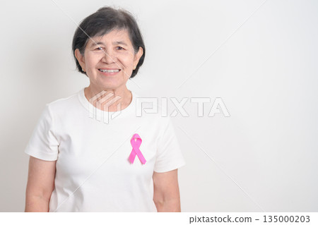 Elderly woman with pink Ribbon for Pink October Breast Cancer Awareness month, May Women Health, February World cancer day, support people life and illness. National cancer survivors month Elderly woman with pink Ribbon for Pink October Breast Cancer Awareness month, May Women Health, February World cancer day, support people life and illness. National cancer survivors month 135000203