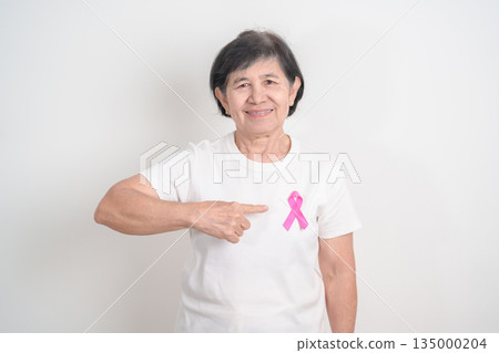 Elderly woman with pink Ribbon for Pink October Breast Cancer Awareness month, May Women Health, February World cancer day, support people life and illness. National cancer survivors month Elderly woman with pink Ribbon for Pink October Breast Cancer Awareness month, May Women Health, February World cancer day, support people life and illness. National cancer survivors month 135000204