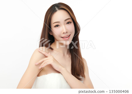 A beautiful young Asian woman with clean, fresh skin against a white background. Skincare, facial treatment, cosmetology, beauty, and spa. An elegant portrait of an Asian woman. 135000406