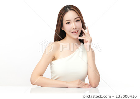 A beautiful young Asian woman with clean, fresh skin against a white background. Skincare, facial treatment, cosmetology, beauty, and spa. An elegant portrait of an Asian woman. A beautiful young Asian woman with clean, fresh skin against a white background. Skincare, facial treatment, cosmetology, beauty, and spa. An elegant portrait of an Asian woman. 135000410