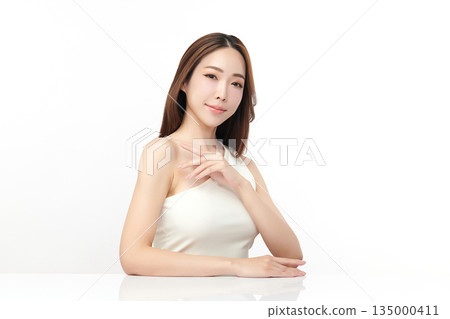 A beautiful young Asian woman with clean, fresh skin against a white background. Skincare, facial treatment, cosmetology, beauty, and spa. An elegant portrait of an Asian woman. A beautiful young Asian woman with clean, fresh skin against a white background. Skincare, facial treatment, cosmetology, beauty, and spa. An elegant portrait of an Asian woman. 135000411