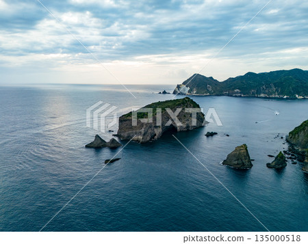 Drone shot of the waters off Hirizohama at dusk. A fishing boat is sailing on a sunset cruise. Hirizohama, Nakagi, Minamiizu Town 135000518