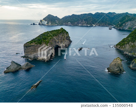 Drone shot of the waters off Hirizohama at dusk. A fishing boat is sailing on a sunset cruise. Hirizohama, Nakagi, Minamiizu Town 135000548
