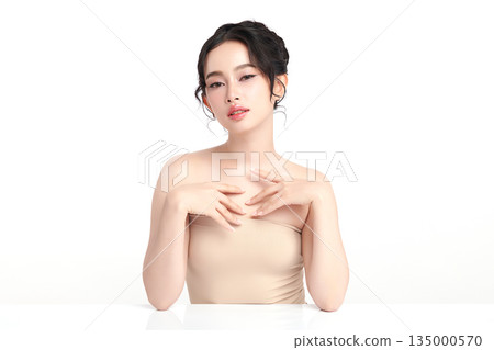A beautiful young Asian woman with clean, fresh skin against a white background. Skincare, facial treatment, cosmetology, beauty, and spa. An elegant portrait of an Asian woman. A beautiful young Asian woman with clean, fresh skin against a white background. Skincare, facial treatment, cosmetology, beauty, and spa. An elegant portrait of an Asian woman. 135000570