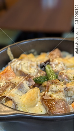 Hot meat dish with plenty of cheese 135000593