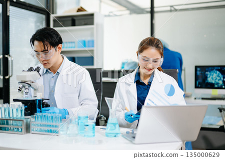 medical discuss meeting with an Asian female scientist supervisor in the laboratory 135000629
