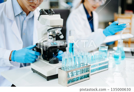 medical discuss meeting with an Asian female scientist supervisor in the laboratory 135000630