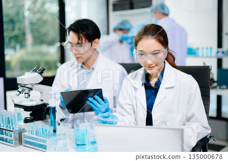 Scientists conducting medical research in a bright lab with microscopes and samples, representing healthcare innovation Scientists conducting medical research in a bright lab with microscopes and samples, representing healthcare innovation 135000678