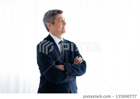 Senior man in a suit looking into the future 135000777