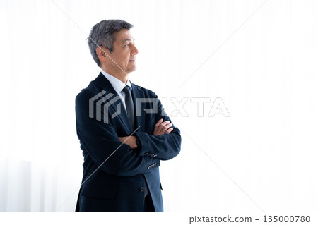 Senior man in a suit looking into the future 135000780