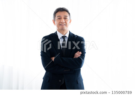 Senior man with a serious expression staring straight ahead 135000789