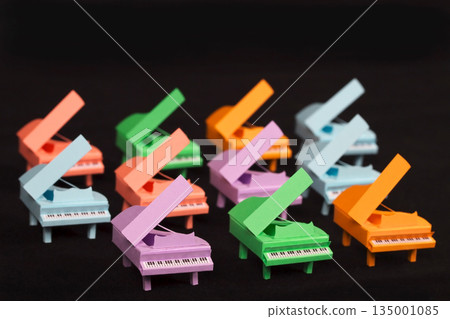 Colorful miniature piano papercraft black background Colorful miniature piano papercraft black background 135001085