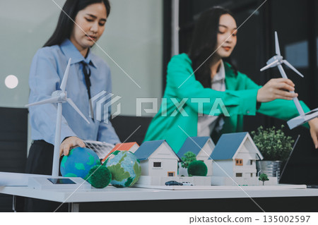 Hands of adult Asian business professionals analyzing ESG financial data and renewable energy project plans Hands of adult Asian business professionals analyzing ESG financial data and renewable energy project plans 135002597