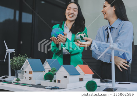 Hands of adult Asian business professionals analyzing ESG financial data and renewable energy project plans Hands of adult Asian business professionals analyzing ESG financial data and renewable energy project plans 135002599