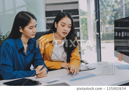 Businesswomen having discussion in office Businesswomen having discussion in office 135002634