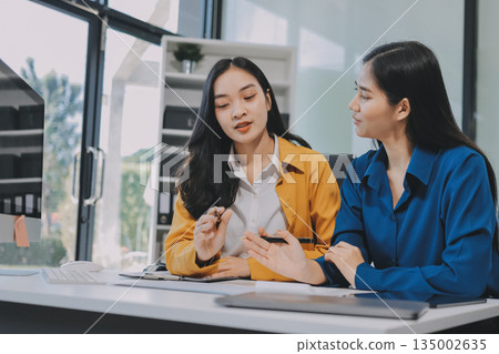 Businesswomen having discussion in office Businesswomen having discussion in office 135002635