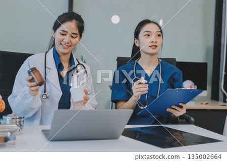 Medical, meeting and laptop for team in office in discussion, brainstorming and planning. Doctor, nurse and computer on desk, teamwork or workshop for Model Internal organ. 135002664