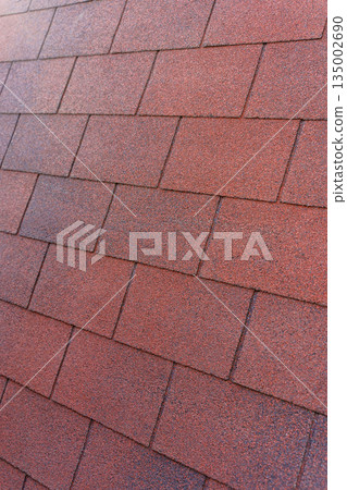 Red Bituminous Roof Shingle Texture Background with Granular Surface 135002690