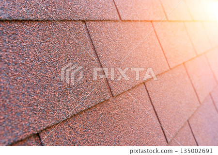 Red Bituminous Roof Shingle Texture Background with Granular Surface Red Bituminous Roof Shingle Texture Background with Granular Surface 135002691
