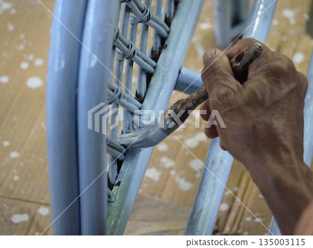 Hand painting chair old hand wooden chair bamboo chair paint brush closeup view pastel color craft work peaceful hand painting 135003115