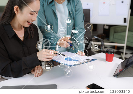 Businessmen team or financial data analysts working with tablets and laptop computers and data graphs together. Plan to analyzing projects in the office. Businessmen team or financial data analysts working with tablets and laptop computers and data graphs together. Plan to analyzing projects in the office. 135003340