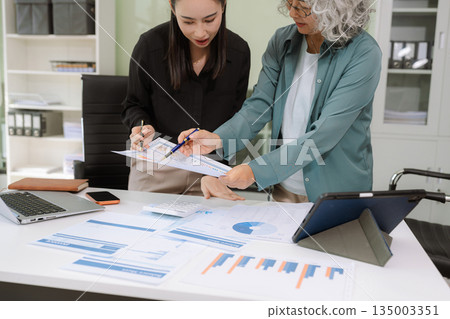 Asian businessman discuss with new startup project Idea presentation, analyze planning and financial statistics and investment market at office. 135003351