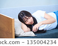 A young Japanese woman taking a comfortable nap in the fa 135004234