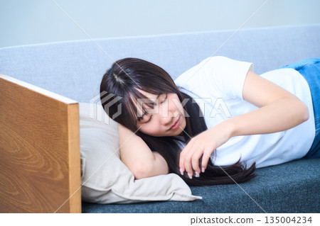 A young Japanese woman taking a comfortable nap in the fa A young Japanese woman taking a comfortable nap in the fa 135004234