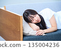 A young Japanese woman taking a comfortable nap in the fa 135004236