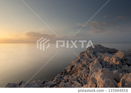 Shirasaki Marine Park: Calm waters and white rocks bathed in the setting sun Shirasaki Marine Park: Calm waters and white rocks bathed in the setting sun 135004858
