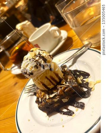 Enjoy a coffee break with chocolate cake topped with ice cream Enjoy a coffee break with chocolate cake topped with ice cream 135005465