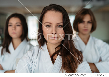 Confident women training karate together. Confident women training karate together. 135005473
