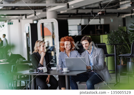 Creative team having discussion over coffee about project strategy. Creative team having discussion over coffee about project strategy. 135005529