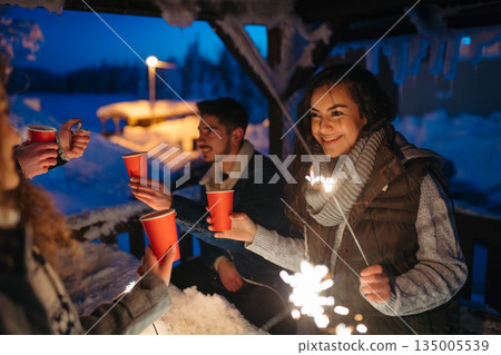 New Year celebration with friends in mountain cabin. New Year celebration with friends in mountain cabin. 135005539