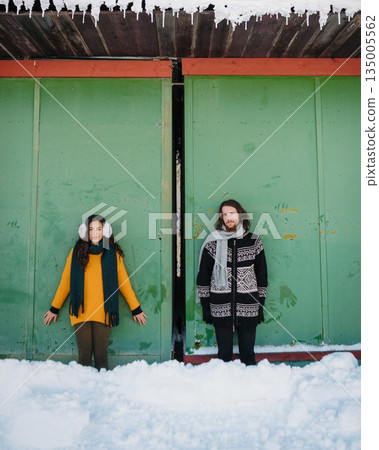Couple walking together on romantic winter date in snowy nature Couple walking together on romantic winter date in snowy nature 135005562