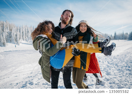 Group of friends enjoying winter time in snowy nature. 135005582
