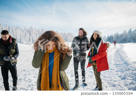 Group of friends enjoying winter time in snowy nature. 135005584