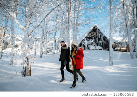Couple walking together on romantic winter date in snowy nature 135005598