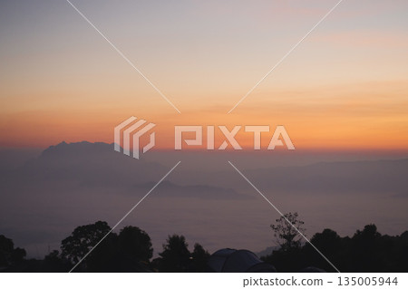 travel and people activity concept with twilight sky before sunrise with mountain and fog on foreground travel and people activity concept with twilight sky before sunrise with mountain and fog on foreground 135005944