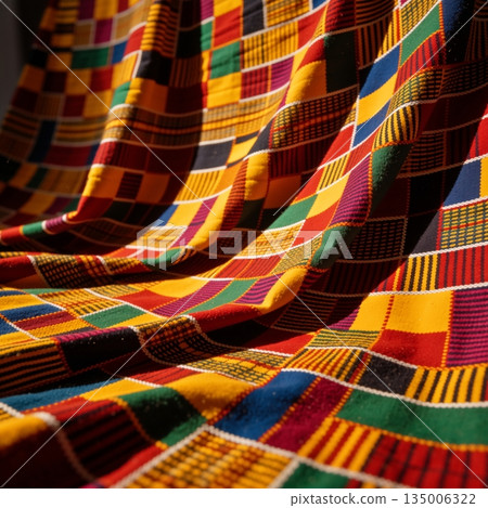 Vibrant Kente cloth pattern with geometric shapes. Traditional African woven textile background from Ghana 135006322